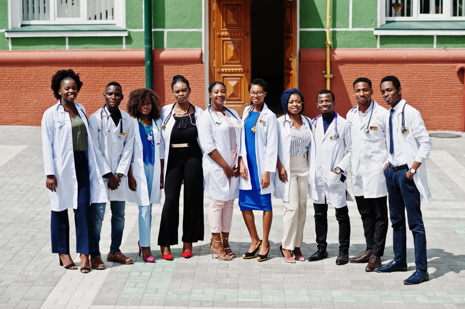 A group of healthcare professionals and students outside a medical university.