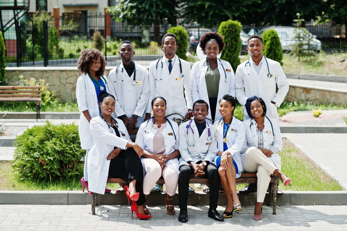 Illustrative photograph of a group in white coats outdoors.